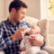 A parent preventing baby bottle tooth decay by brushing their toddler's milk teeth before visiting a paediatric dentist at Adelaide DentalCare.