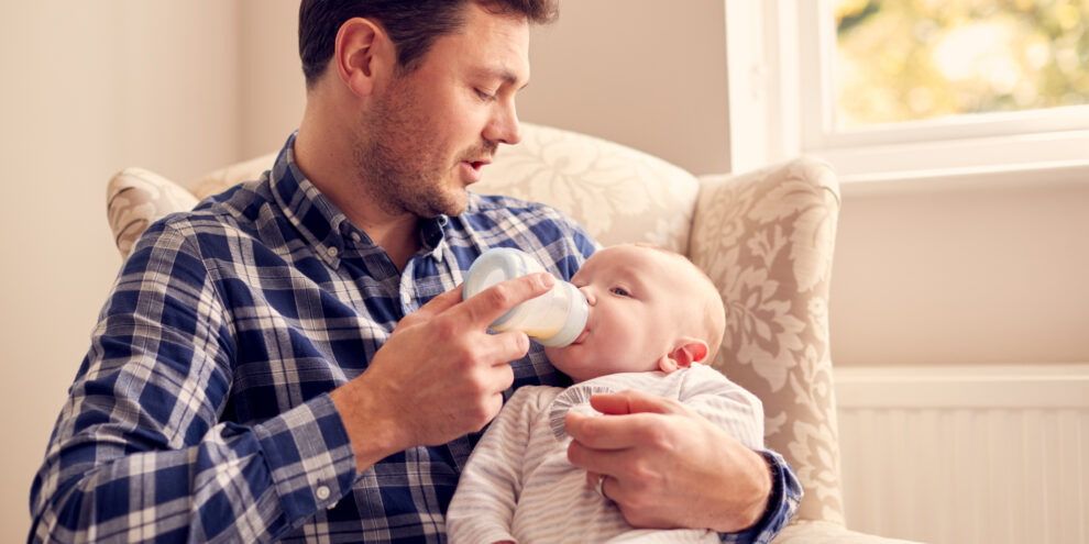 A parent preventing baby bottle tooth decay by brushing their toddler's milk teeth before visiting a paediatric dentist at Adelaide DentalCare.