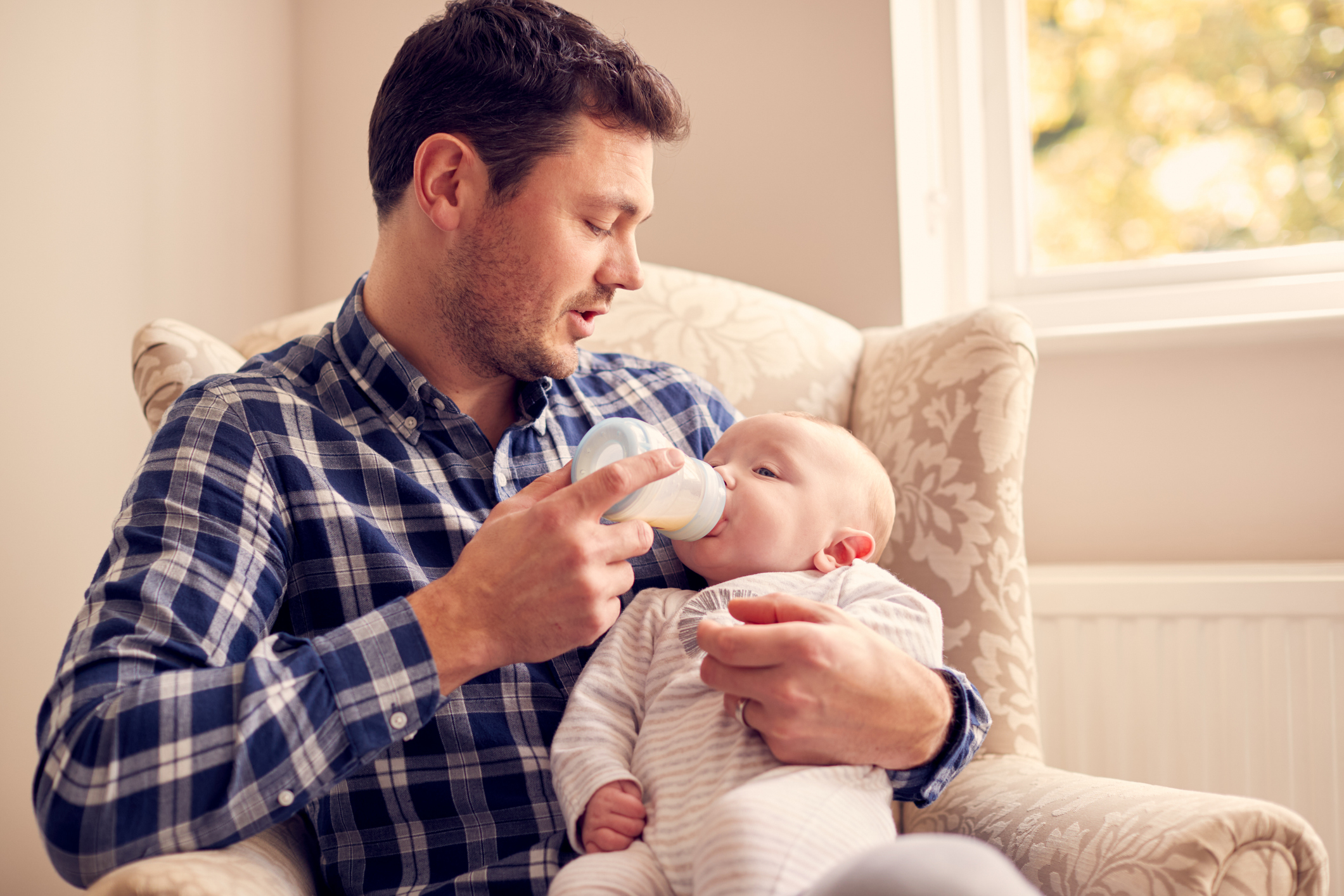 A parent preventing baby bottle tooth decay by brushing their toddler's milk teeth before visiting a paediatric dentist at Adelaide DentalCare.